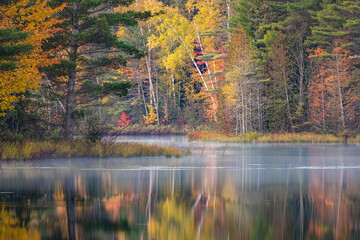 Sticker - Autumn sunrise reflection on mirrored lake, Upper Peninsula of Michigan