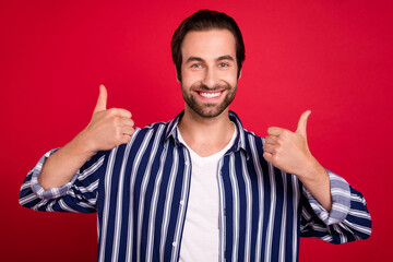 Wall Mural - Photo of young cheerful man show thumbs-up ad promo approve suggest isolated over red color background