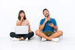 © luismolinero - Young couple sitting on the floor holding pc and mobile phone isolated on white background thinking an idea while looking up