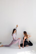© kalinichenkod - Beautiful sporty women do exercises on a white background. Fitness.