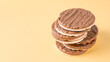 © Volha - Stack of round rice cakes covered with dark chocolate on yellow background. Healthy Gluten Free cereal crispbread.