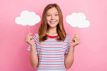 Poster - Photo of pretty teenager brown hairdo girl hold clouds wear striped t-shirt isolated on pink color background