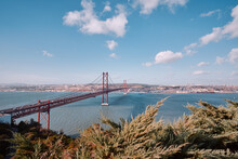 Beautiful Landscape With Suspension 25 April Bridge Bridge Over The Tagus River In Lisbon, Portugal.
