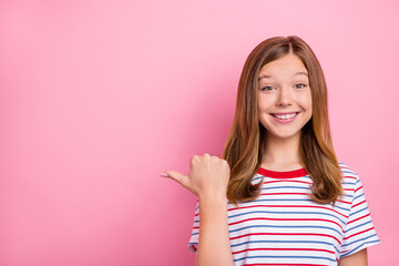 Wall Mural - Photo of pretty little blond girl index empty space wear striped t-shirt isolated on pink color background