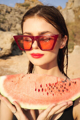 Wall Mural - woman eating watermelon outdoors Sun summer close-up