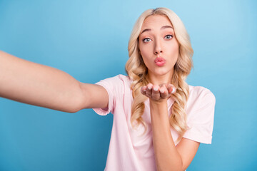 Poster - Photo of flirty millennial blond lady do selfie blow kiss wear pink t-shirt isolated on blue color background