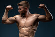 © speed300 - Sporty and healthy muscular man isolated on black background. He showing his muscles and feeling strong. Stock photo