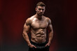 © speed300 - Fitness model showing his perfect body isolated on dark background. Bodybuilder man with perfect abs, shoulders, biceps, triceps and chest. Strong athletic man concept