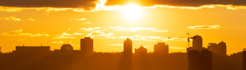 Wall Mural - Panorama sunset in city with building silhouette and construction crane, Kiev city