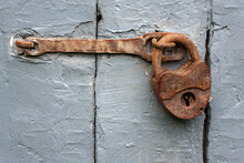 Vintage Rusty Locked Padlock On A Blue Wooden Door