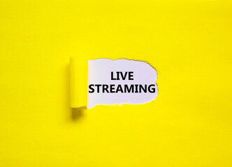Live streaming symbol. Concept words Live streaming appearing behind torn yellow paper. Beautiful yellow background. Business, live streaming concept, copy space.