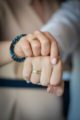 Hands of the bride and groom with wedding rings