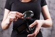 a woman with a magnifying glass looks at an empty wallet