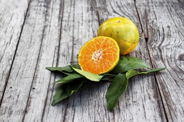 Poster - Fresh orange fruit on wood background