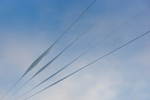 Snow, Ice And Icicles On Wires On Blue Sky