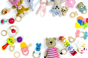 Wall Mural - Various children's toys and rattles are scattered on a white background with copy space. Children's background.