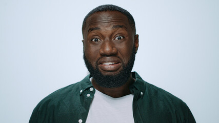 Portrait of emotional african man posing with face expression in studio.