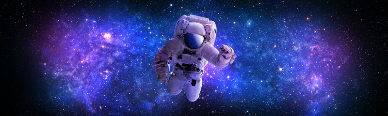 Astronaut flying in outer,open space,which is behind.Abstract space background with blue purple nebula and stars.sci-fi abstract futuristic space background Elements of this image furnished by NASA