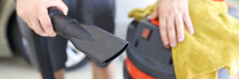 Man Cleaner Holding Pipe From Professional Vacuum Cleaner And Microfiber Cloth Closeup