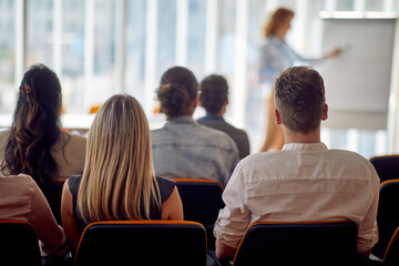 a group of young business people attends a business lecture in the conference room. business, people