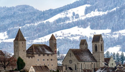 Wall Mural - Stunning skyline of the iold city of Rapperswil St. Gallen with the snow covered mountains of the highlands of Zurich (Zürcher Oberland) in the background. Switzerland