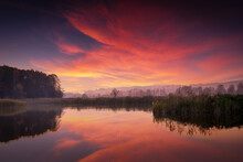Beautiful Sunrise Over The Lake. Autumn Sunrise Over The Zemborzycki Reservoir. Reflections In The Water.