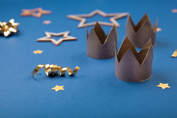 Three gold crowns for Traditional Three King's Day of January 6, blue background.