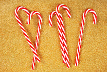 Candy Canes On Gold Background. Christmas Decoration
