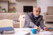 © Elnur - Old male employee working from home during pandemic