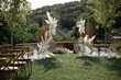 Chairs made of natural wood on the grass and wedding decorations