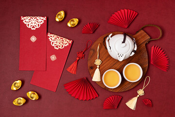 Wall Mural - Chinese new year festival decoration. Traditional lunar new year flat lay with green tea, red paper fans, cherry blossom. Top view