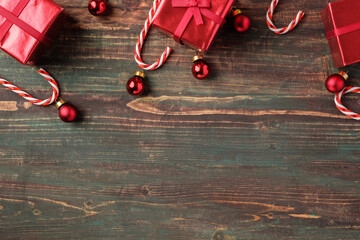 Poster - Christmas red bauble, gift box,candy cane decoration on table wood background