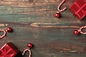Poster - Christmas red bauble, gift box,candy cane decoration on table wood background