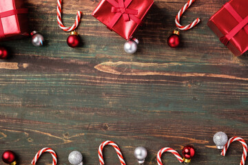 Poster - Christmas red bauble, gift box,candy cane decoration on table wood background