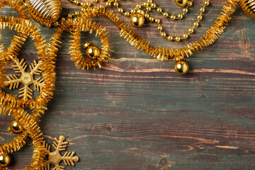 Poster - Christmas gold bauble and tinsel decoration ornament on table wood background