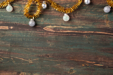 Poster - Christmas gold bauble and tinsel decoration ornament on table wood background