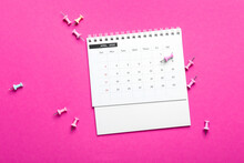Flip Paper Calendar For April 2022 And Pins On Color Background