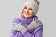 © Pixel-Shot - Woman in winter clothes on grey background