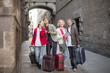 © caftor - tourists with suitcases and camera walk along the historic streets of European city