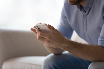 Wall Mural - close up hands of male user using online app on mobile phone. young man chatting on cellphone, using