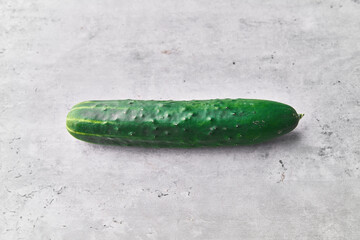  Single cucumber on a marble surface