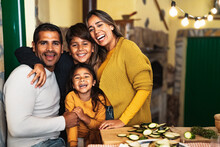 Happy Hispanic Family Enjoying Holidays Together At Home