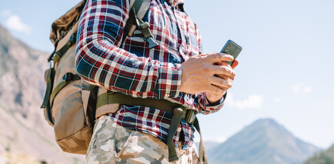 Wall Mural - one person using mobile phone in the mountains