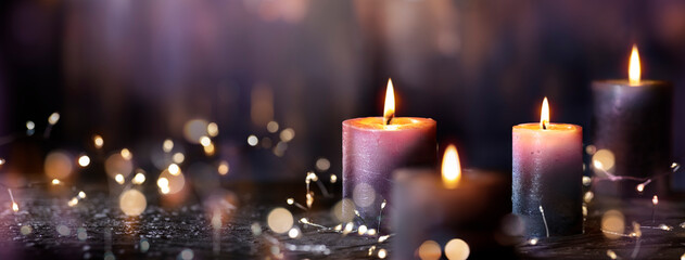 Advent Candles - Four Purple Votive Candlelight In Church With Defocused Abstract Lights