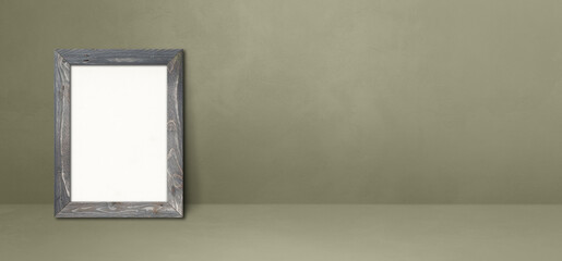 Poster - Wooden picture frame leaning on a grey wall. Horizontal banner