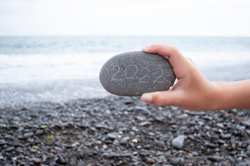 stone with 2022 inscription by the sea