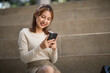 © David - Portrait of young student girl, Excited student checking smartphone content in a campus,The study, education, university, college, graduate concept