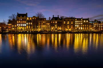 Poster - City scenic from Amsterdam at the river Amstel in the Netherlands at sunset