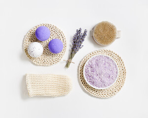 Wall Mural - Natural lavender bath bombs and sea salt with essential oil, dried lavender flowers. Exfoliating loofah sponge, massaging brush for body treatment, health and self-care, aromatherapy