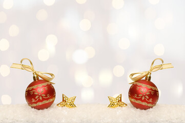 Red ball with an ornament on white snow. Christmas holiday.